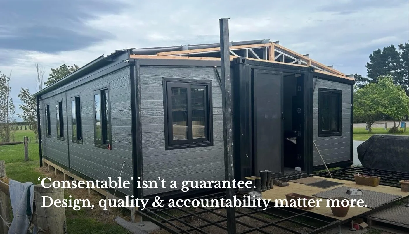 A grey expandable modular home under construction on a New Zealand section