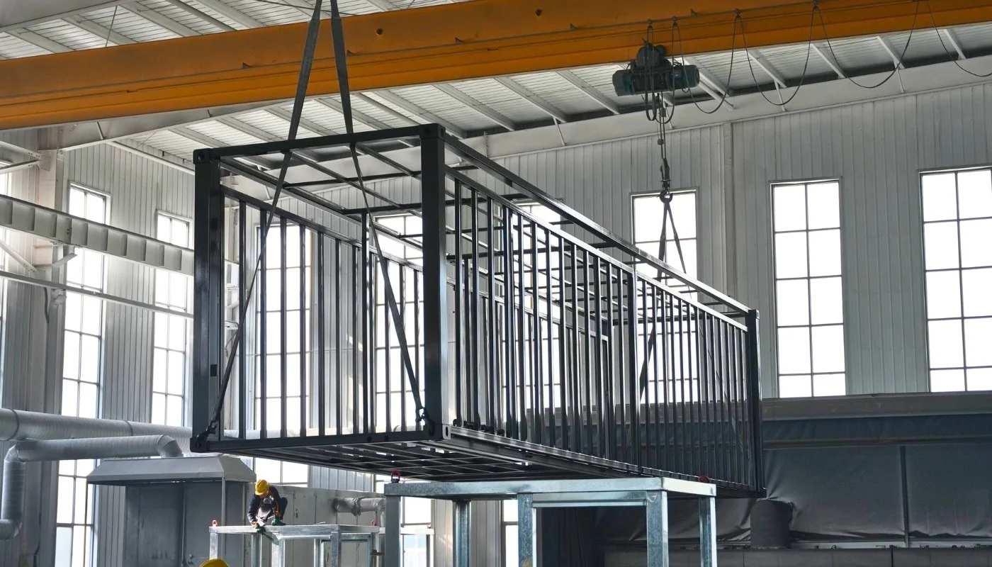 A steel-framed expandable module being assembled in a factory