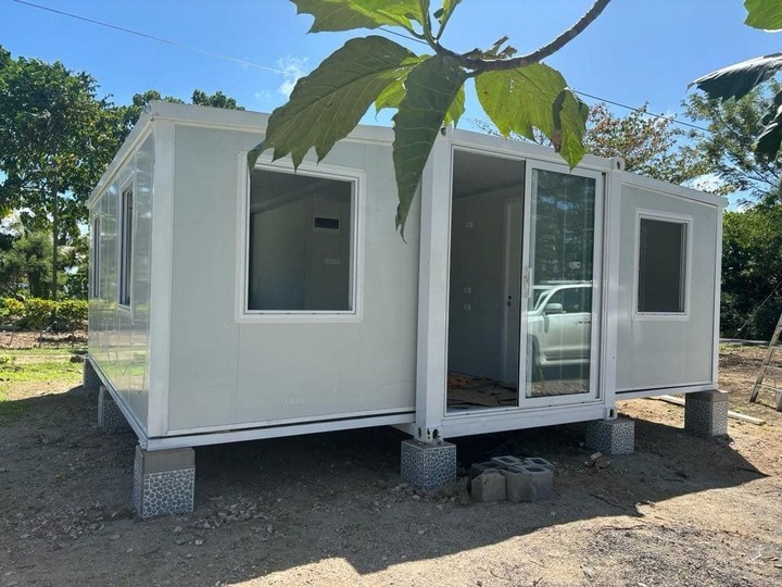 A modern white expandable prefab tiny home suited to a backyard site