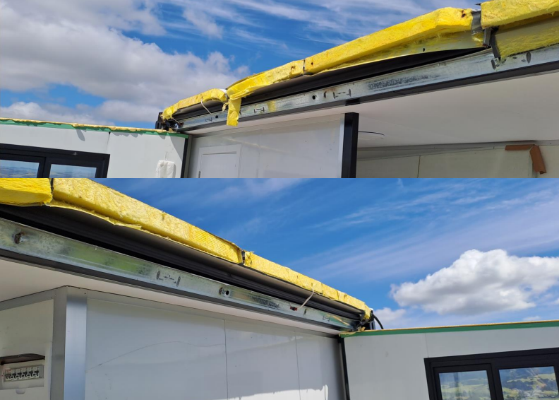 Exposed roof insulation and unfinished edge flashing on a prefab unit