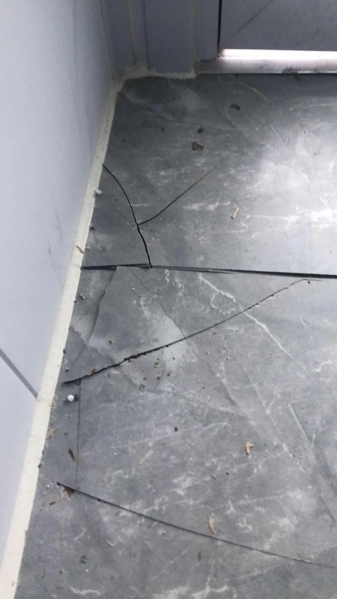 Cracked tile flooring inside a poorly finished portable cabin